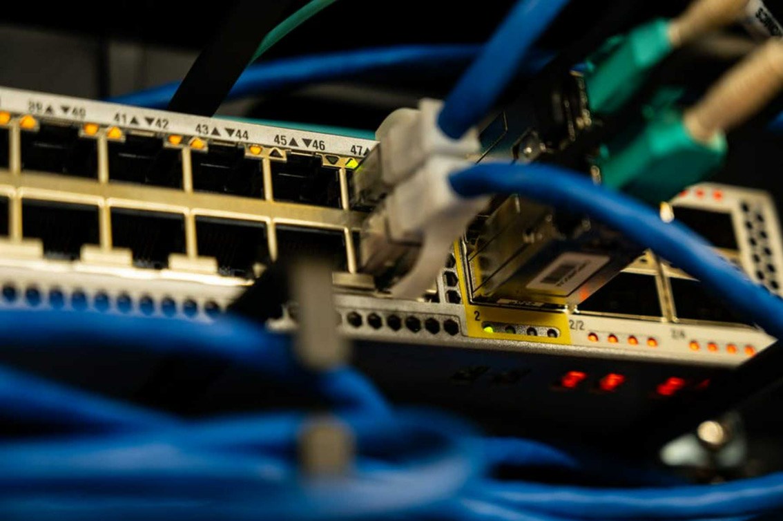 A network switch with cables plugged in to several of its ports