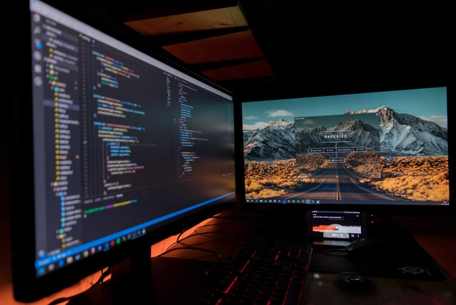 Two computer monitors on a desk.