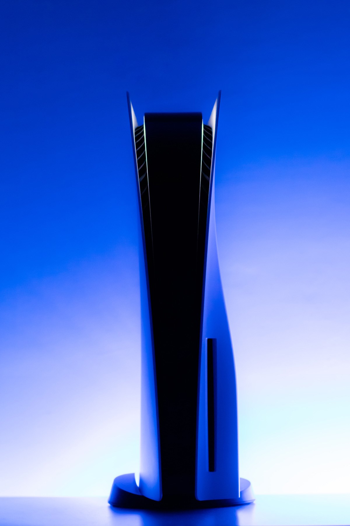 A Playstation 5 console standing vertically, viewed from the front.