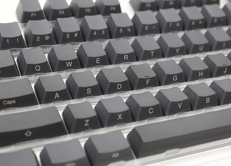 Close-up of Ducky's grey keycaps with the engraving on the sides instead of on top.