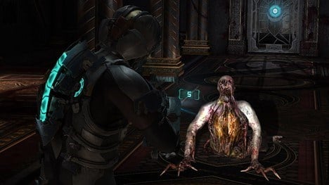 Dead Space 2 screenshot showing creature crawling and main character aiming weapon