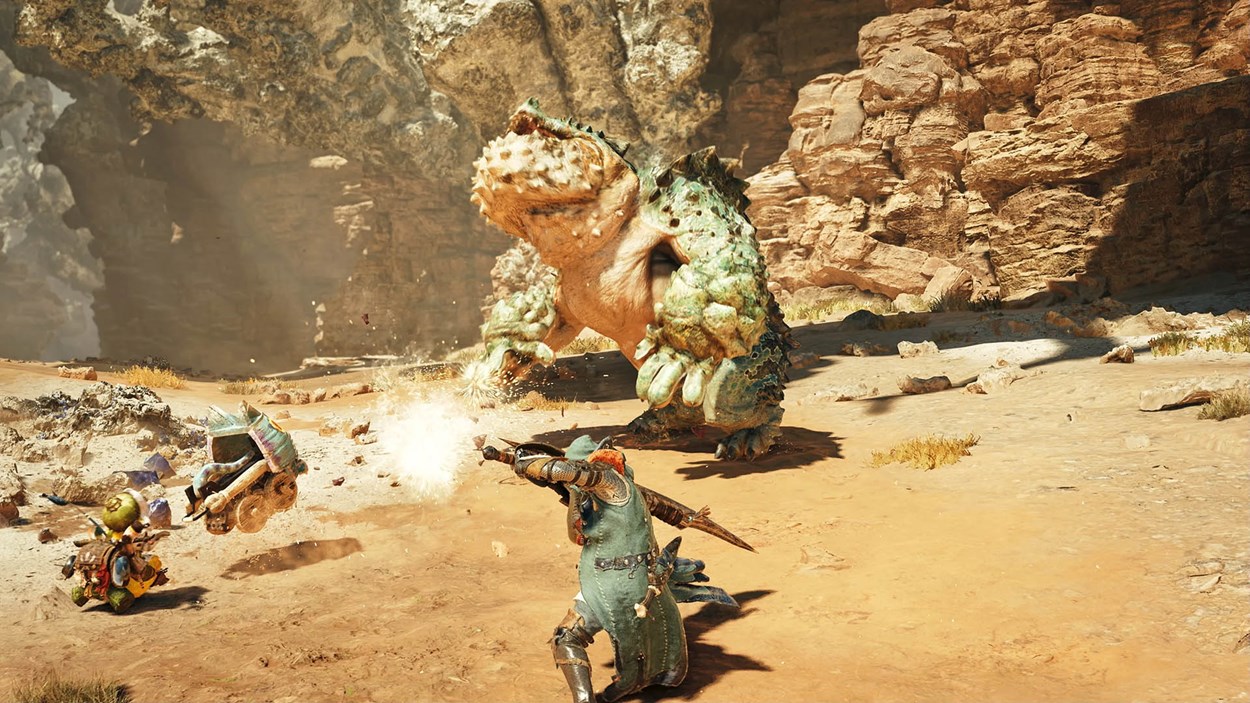 A hunter clad in armor battles a large, frog-like monster with rocky green scales in a sunlit desert canyon in Monster Hunter Wilds, while a Palico companion assists with an explosive cart.