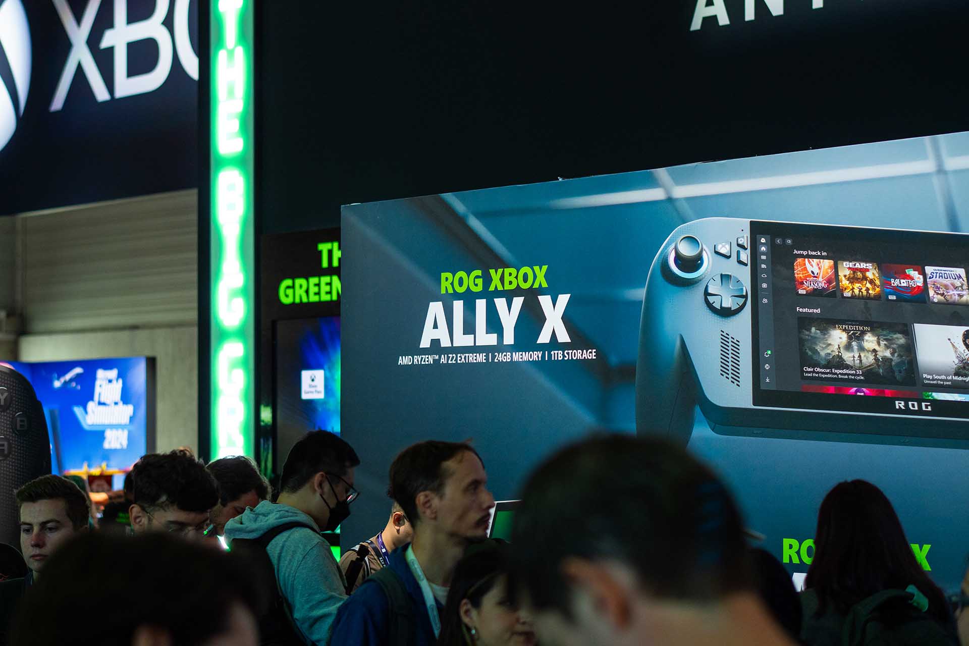 Crowds at Gamescom 2025 gathered around the ASUS ROG Xbox Ally X booth, showcasing the handheld gaming device with game previews on screen.
