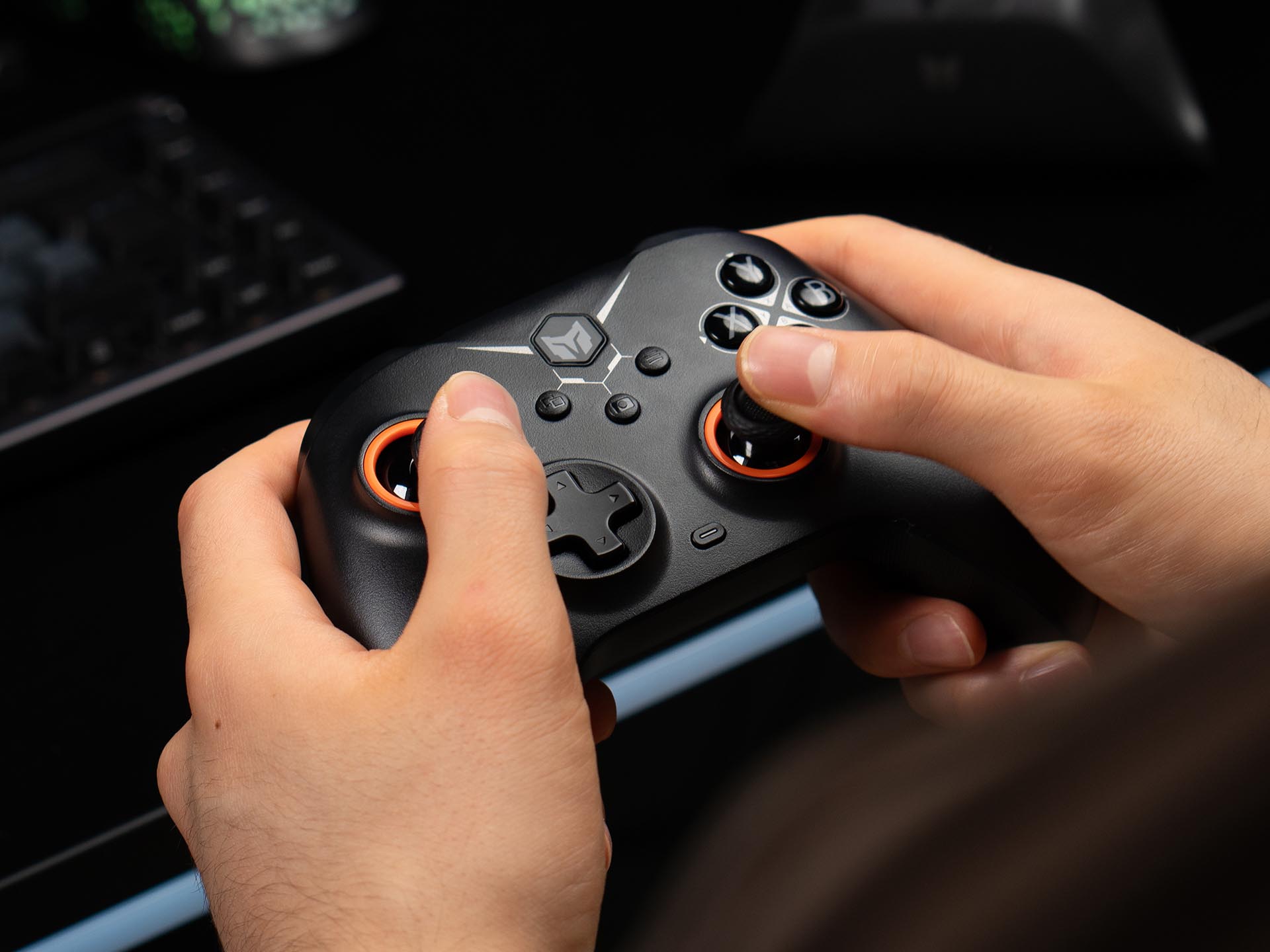 Gamer holding a black BIGBIG WON Gale Hall wireless controller, showing its ergonomic design and precise thumbstick control during gameplay.