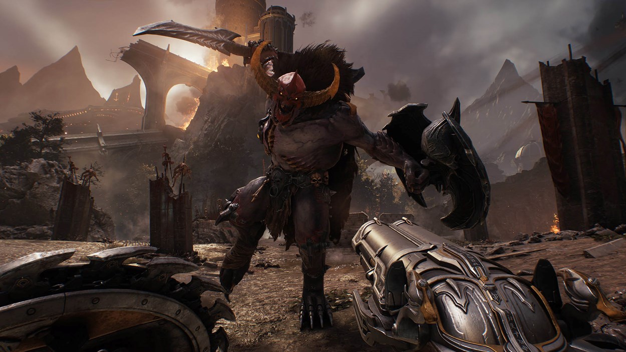 First-person view of the Doom Slayer facing a towering horned demon wielding a massive sword and shield in a ruined medieval battlefield from Doom: The Dark Ages.