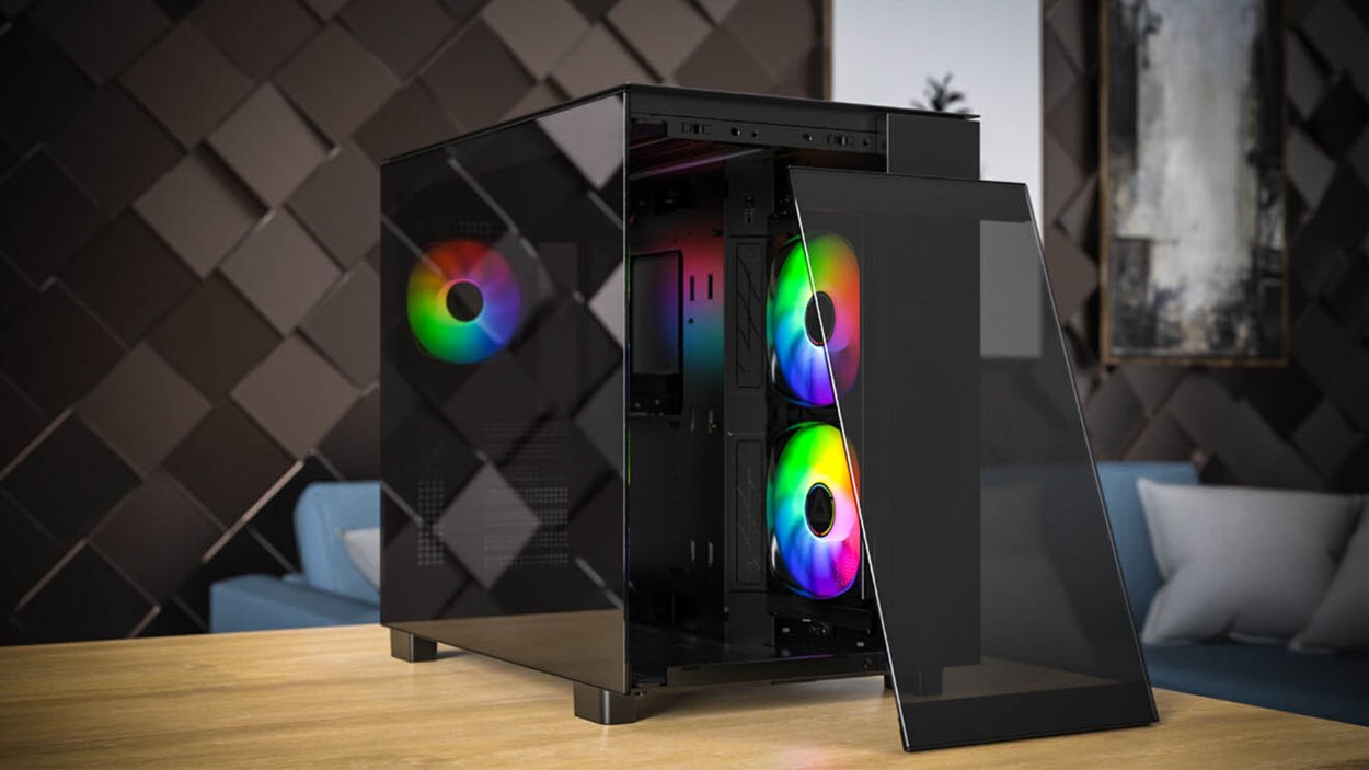Montech King 65 Pro mid-tower PC case with tempered glass panels and three ARGB fans, displayed with the front panel open on a wooden table.