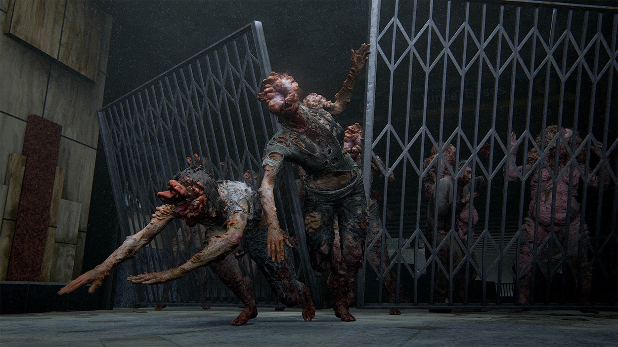 Clickers and infected break through metal gates in a dark, abandoned subway station in The Last of Us Part II Remastered, showcasing grotesque detail and intense atmosphere.