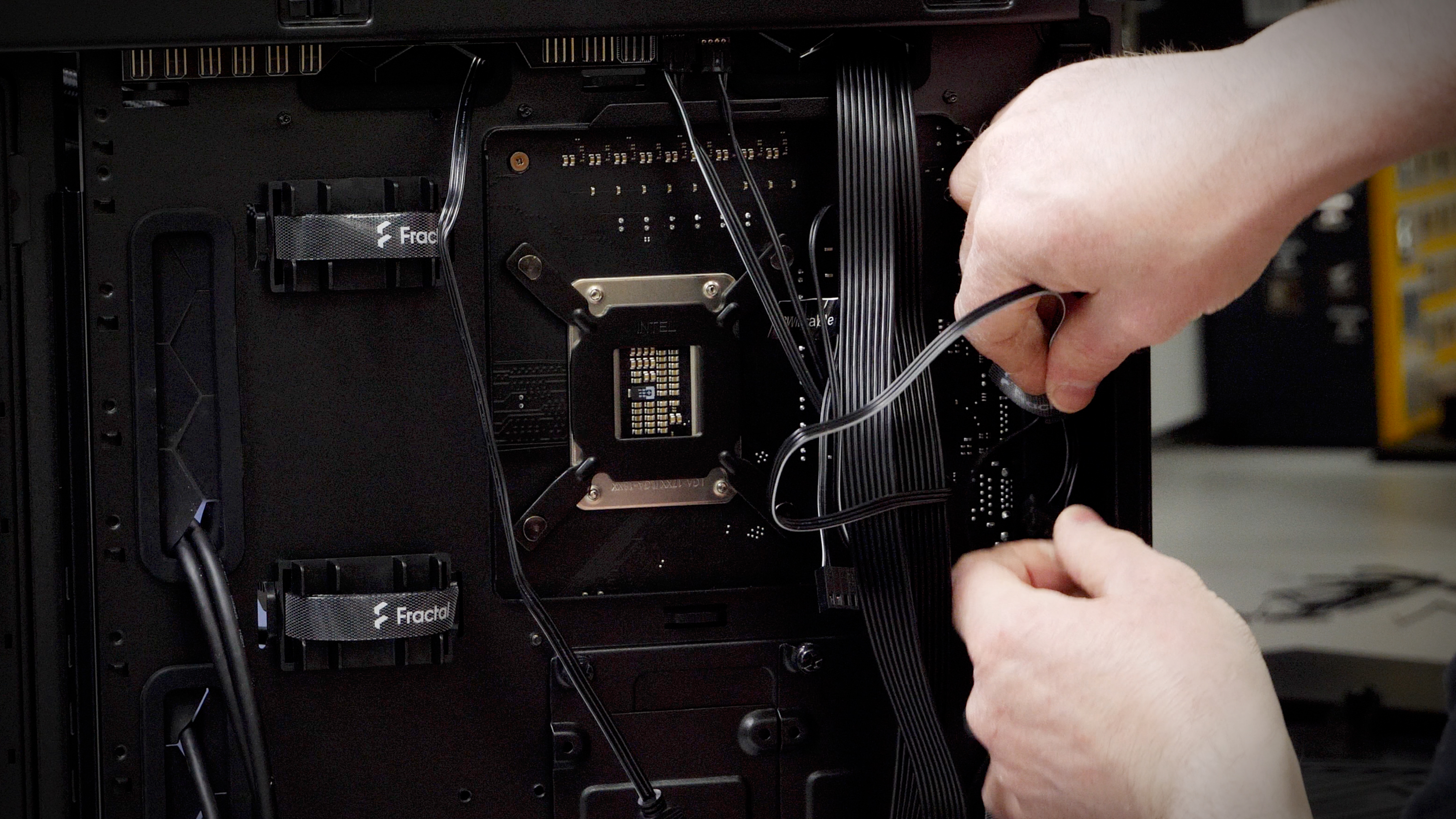 Person organising wiring inside PC