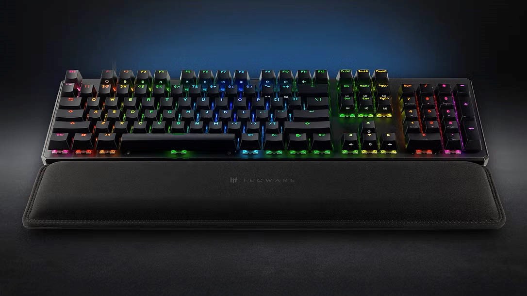 Tecware mechanical keyboard with full RGB backlighting paired with a black Tecware wristpad, designed for comfort during extended gaming or typing sessions.