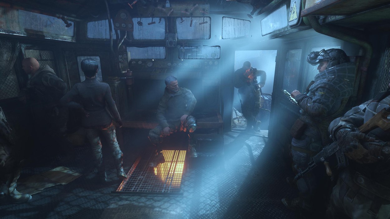 Scene from Metro Exodus showing a dimly lit train cabin with soldiers and survivors gathered. Blue light filters through broken windows, creating an atmospheric, post-apocalyptic setting.