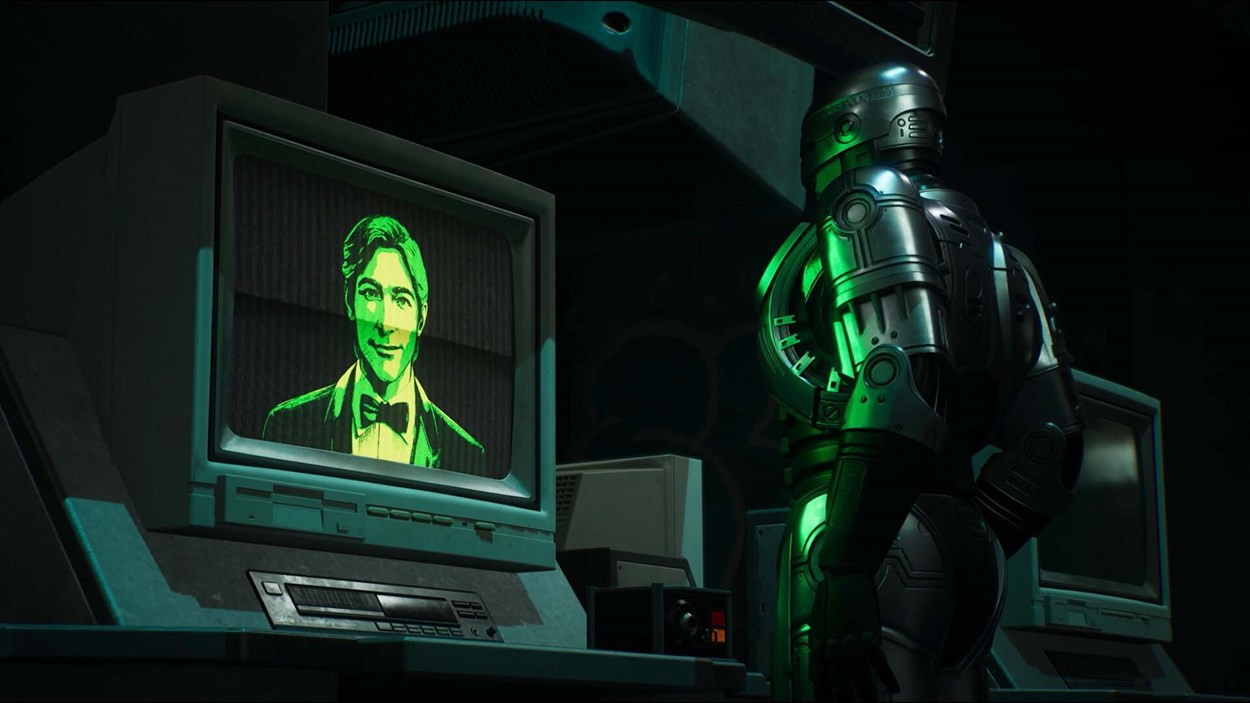 RoboCop stands in front of an old CRT monitor displaying a green-tinted face of an AI or character, in a dimly lit room filled with retro computer equipment.