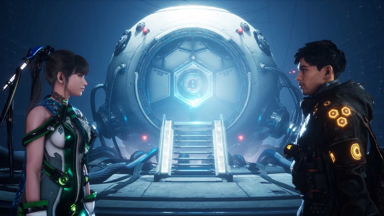 Two futuristic characters face each other inside a sci-fi facility, standing before a glowing, high-tech chamber.