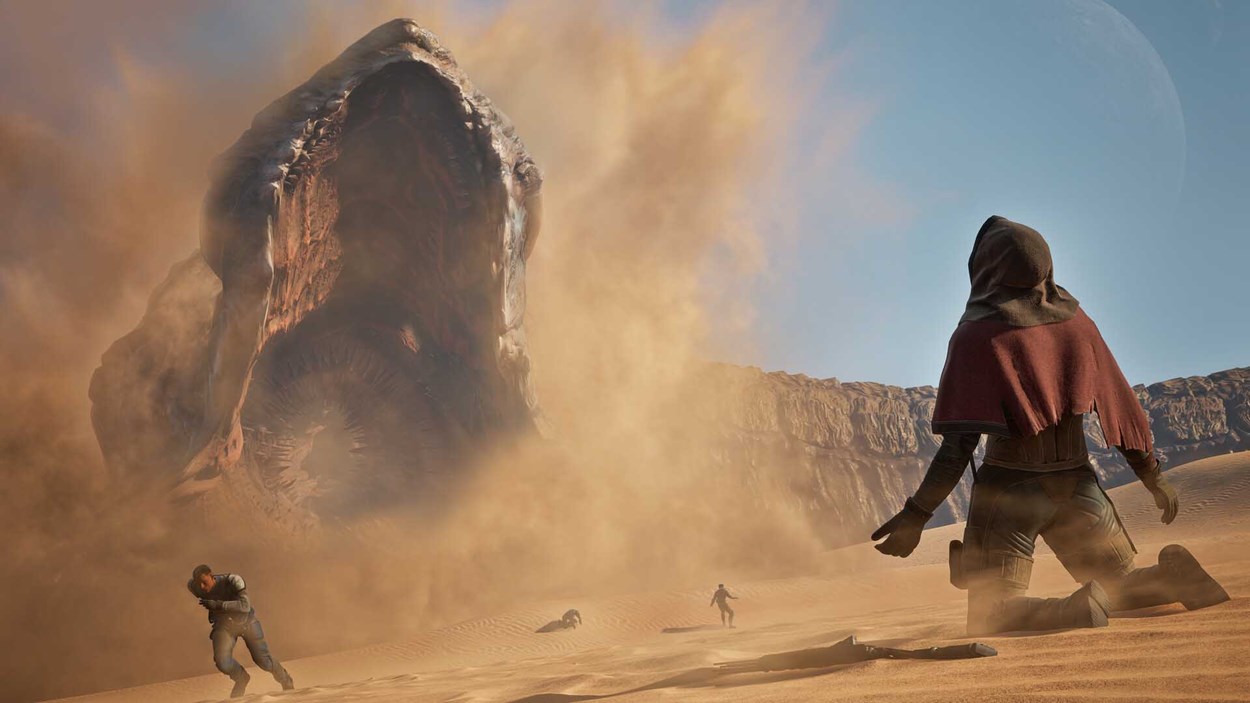 Massive sandworm erupts from the desert as panicked characters flee, while one kneels calmly in the foreground under a clear sky with a distant planet visible.