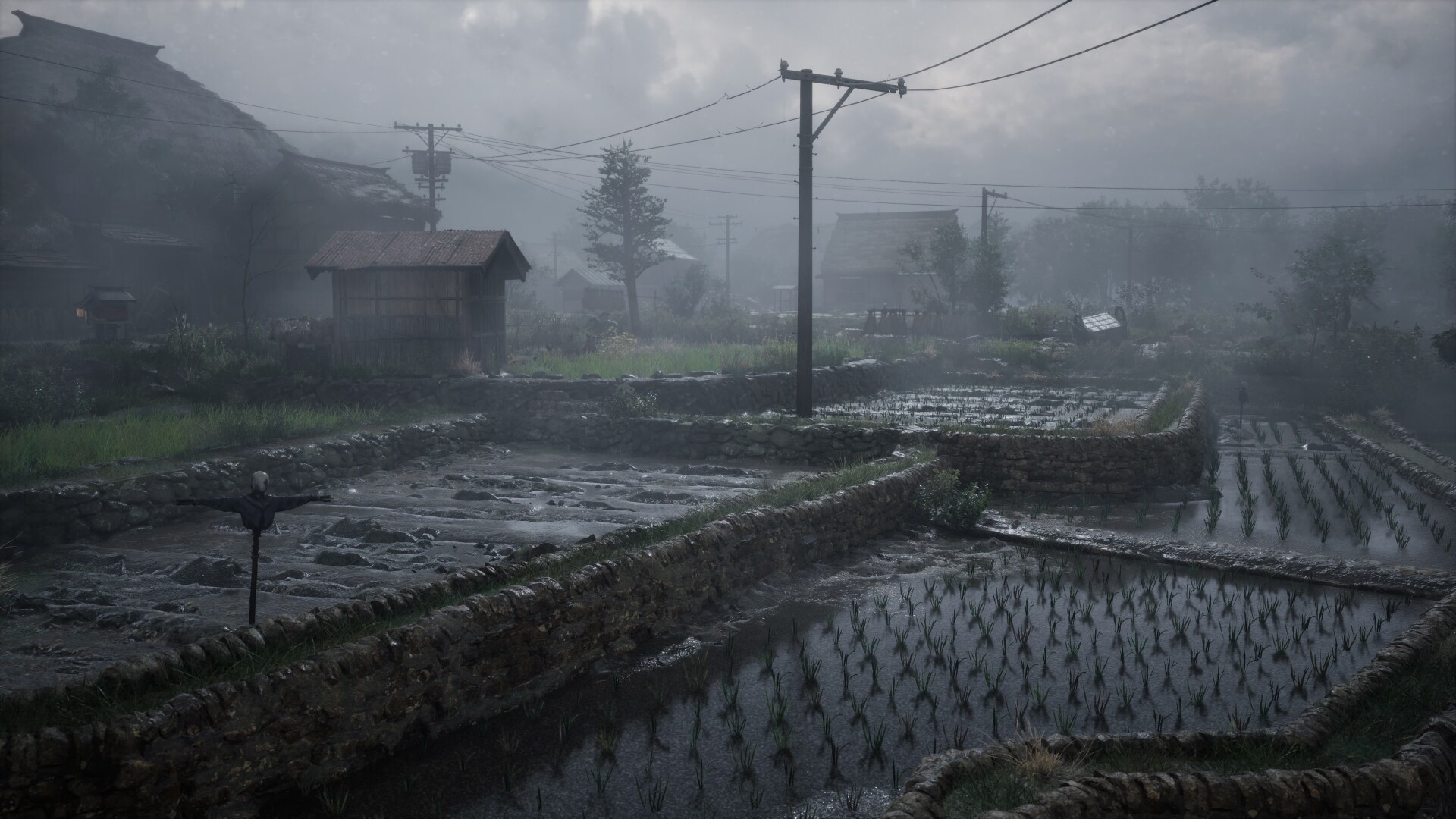 Silent Hill f countryside scene showing misty rice fields, stone walls, and small wooden huts under a gloomy, overcast sky.