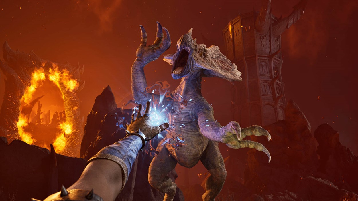 Player character casting a frost spell at a Daedric creature in the fiery realm of Oblivion, with a blazing Oblivion gate and ominous tower in the background—highlighting intense first-person combat in Oblivion Remastered.