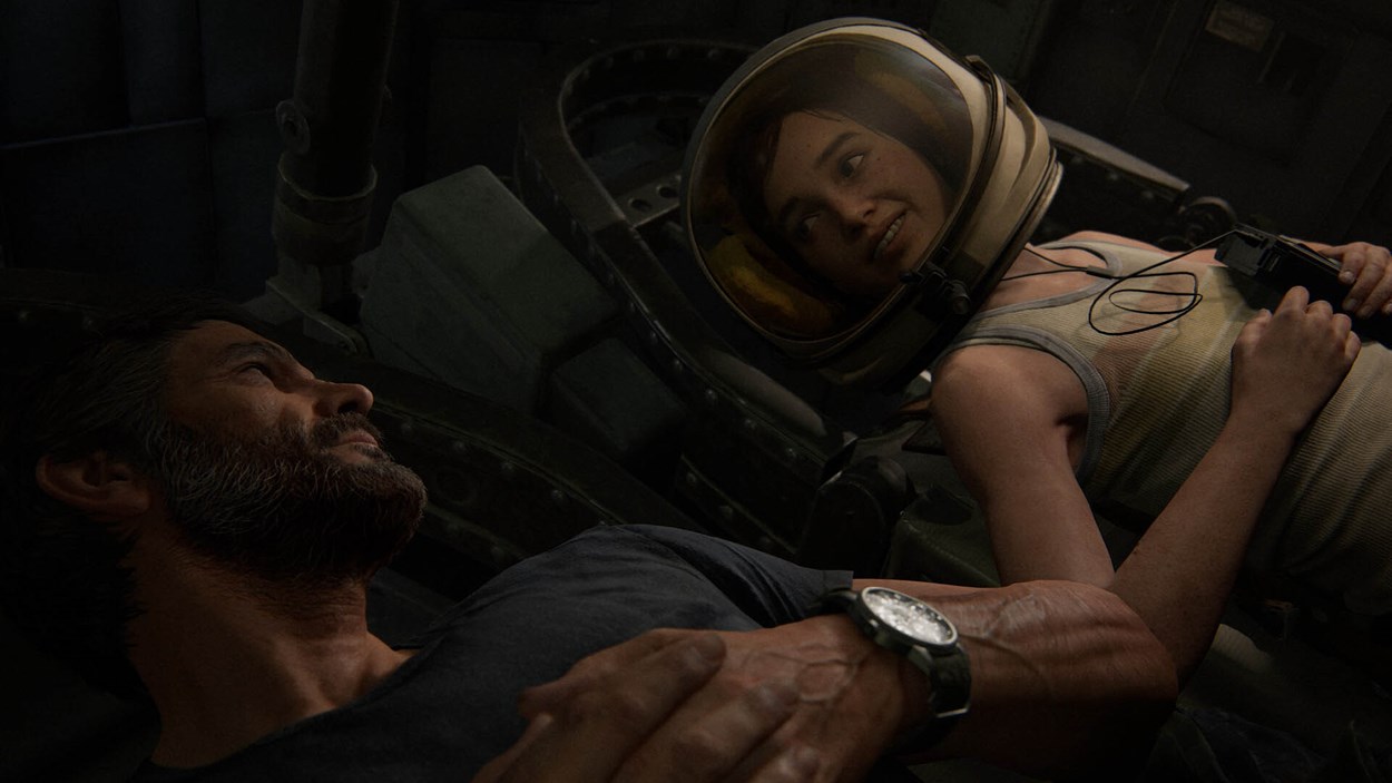 Joel and Ellie share a quiet, emotional moment inside a space shuttle in The Last of Us Part II Remastered, with Ellie wearing an astronaut helmet and smiling during a heartfelt flashback.