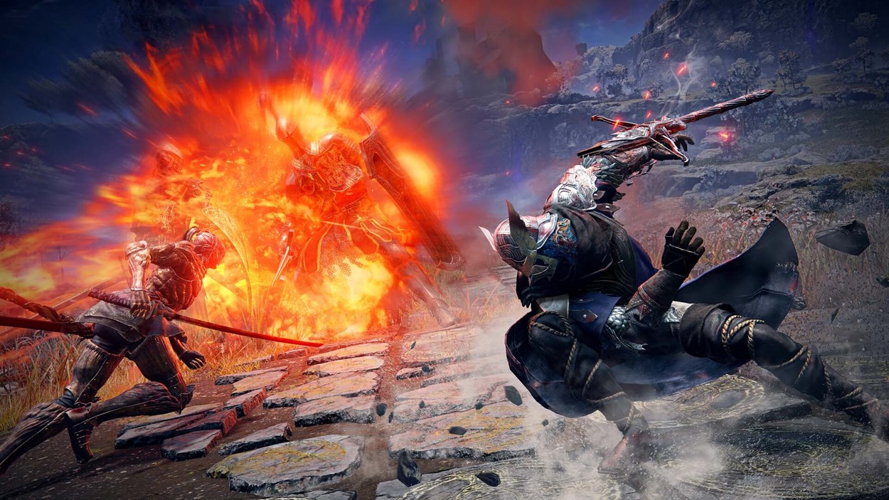 Fierce combat scene in Elden Ring: Nightreign, showing two warriors attacking a fiery armored enemy erupting in flames on a stone path, with intense visual effects and dynamic motion.