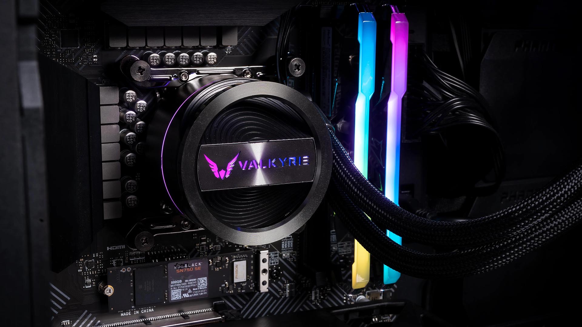 Valkyrie Dragonfang 240 AIO liquid cooler with RGB pump lighting installed on a motherboard beside illuminated RAM.