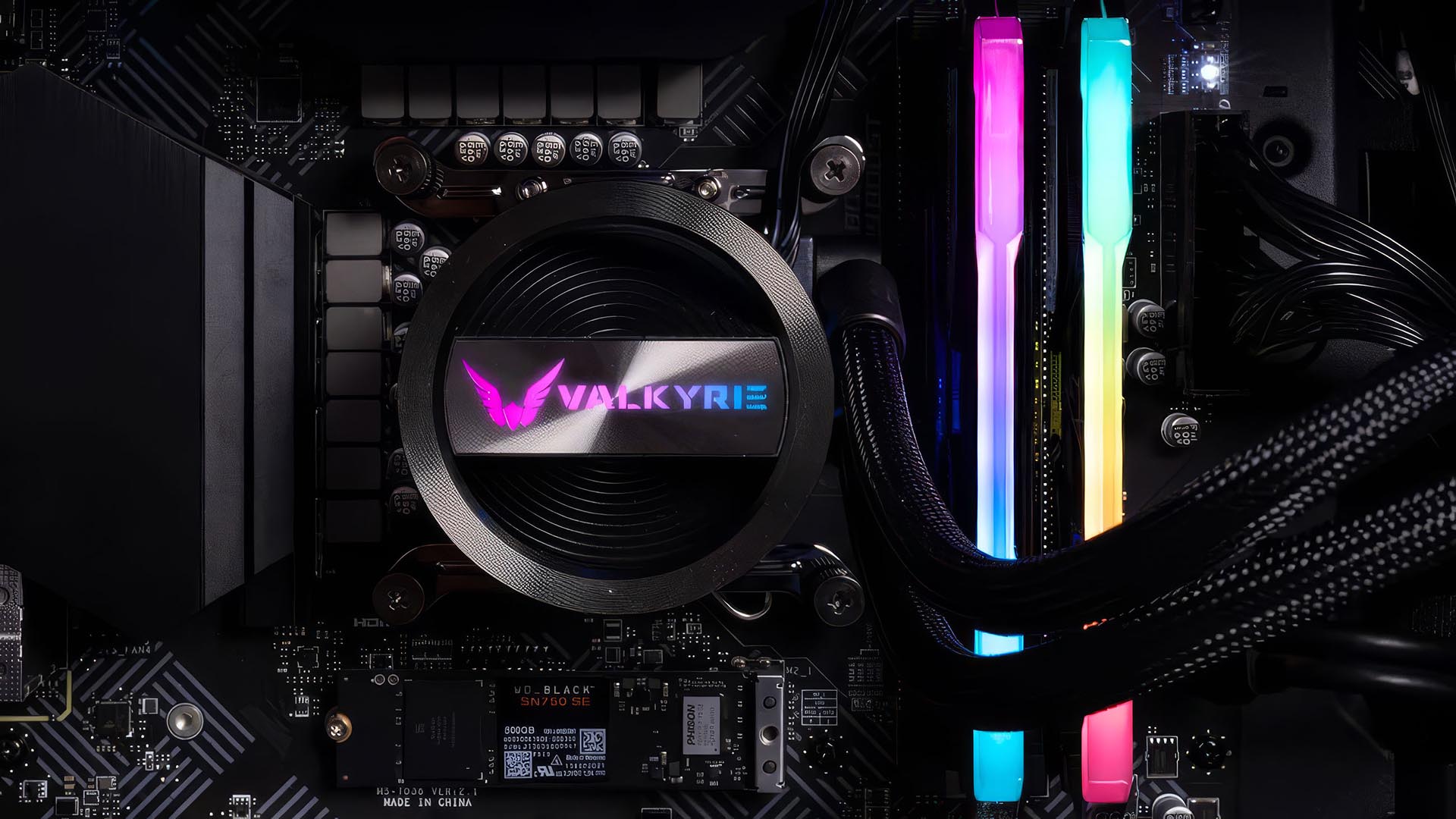 Valkyrie Dragonfang 240 AIO liquid cooler installed on a motherboard with RGB pump lighting and illuminated RAM sticks.