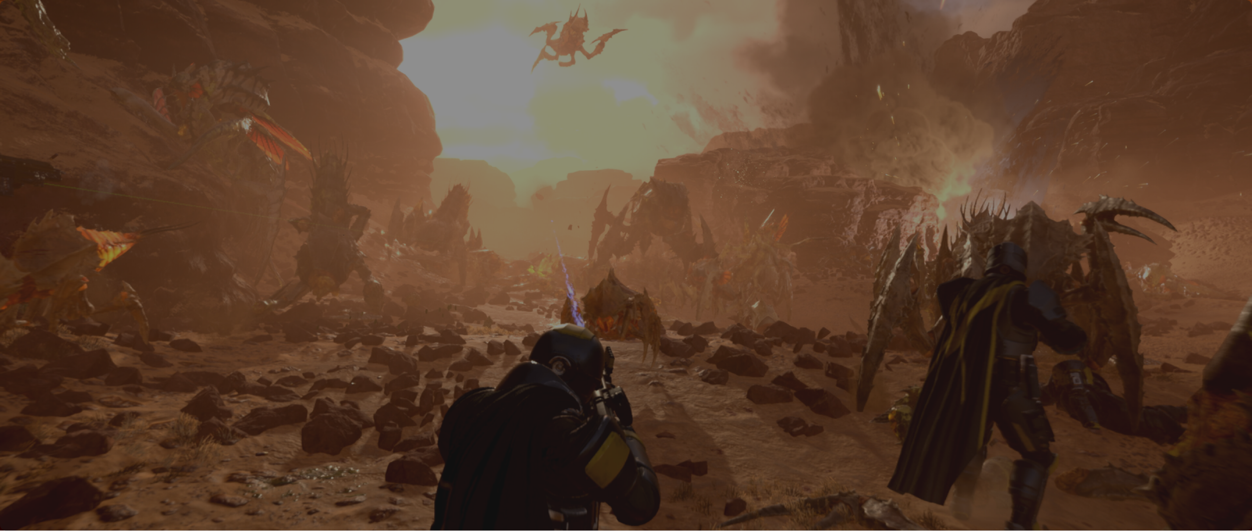 A helldiver being overrun by the bugs whilst fighting a war in a sand filled area.